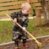 Child Raking Leaves wearing Mud MatesWaterproof Green Camo Children's Coveralls