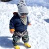 Toddler wearing Mud Mates NZ-made camo print waterproof fleece lined pants on the snow