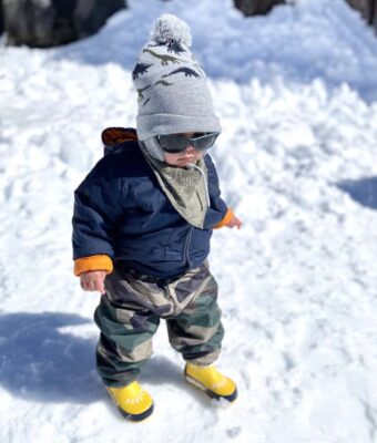 Toddler wearing Mud Mates NZ-made camo print waterproof fleece lined pants on the snow