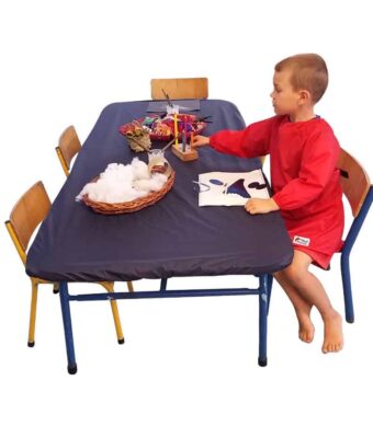 Navy, rectangle NZ-made elasticated Fitted Tablecloth protecting a table during arts and crafts at an early childcare centre.