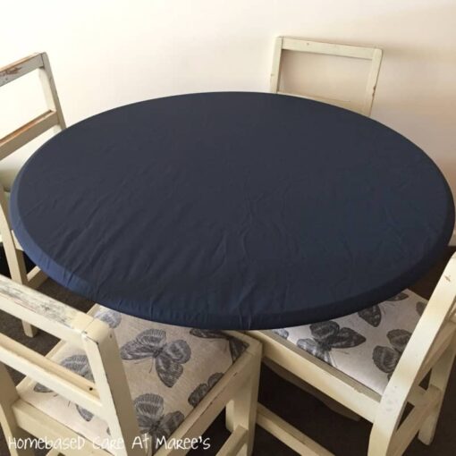 Navy blue round elasticated fitted tablecloth on a table