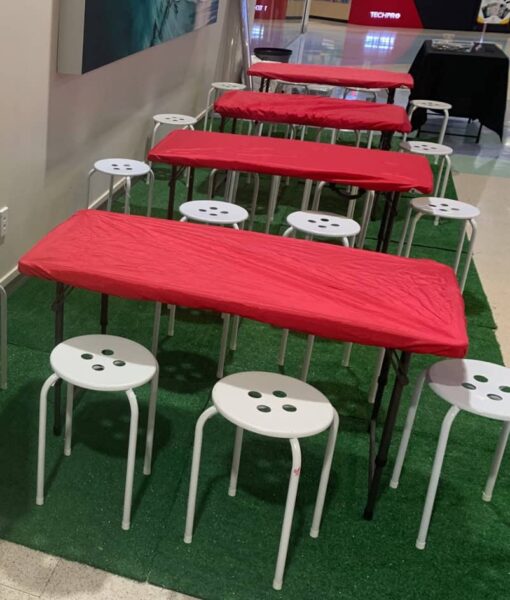 Red, rectangle NZ-made elasticated Fitted Tablecloths protecting a tables for an art session