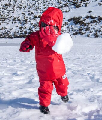Child wearing Mud Mates waterproof Fleece Pants while playing in the snow