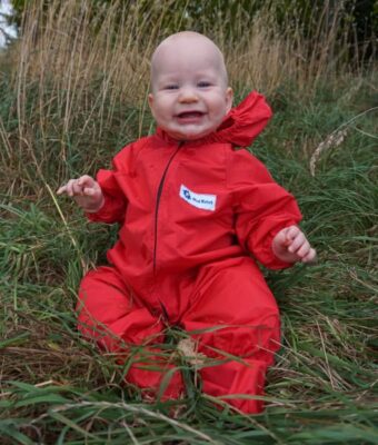 Crawler wearing Mud Mates NZ-made waterproof coveralls and shoe covers. Save money with a Busy Crawler Pack