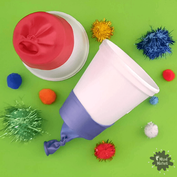 Pom pom shooter and pom poms ready to play with