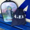 Navy Kids Waterproof Swim Bag / / Wet Bag sitting on bench with a school bag ready for swimming lessons