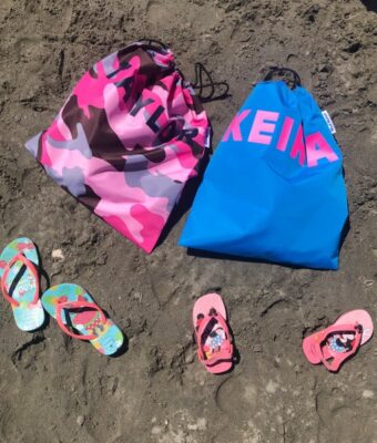 NZ-Made Waterproof Swim Bags / Wet Bags - Pink Camo and Turquoise bags on beach