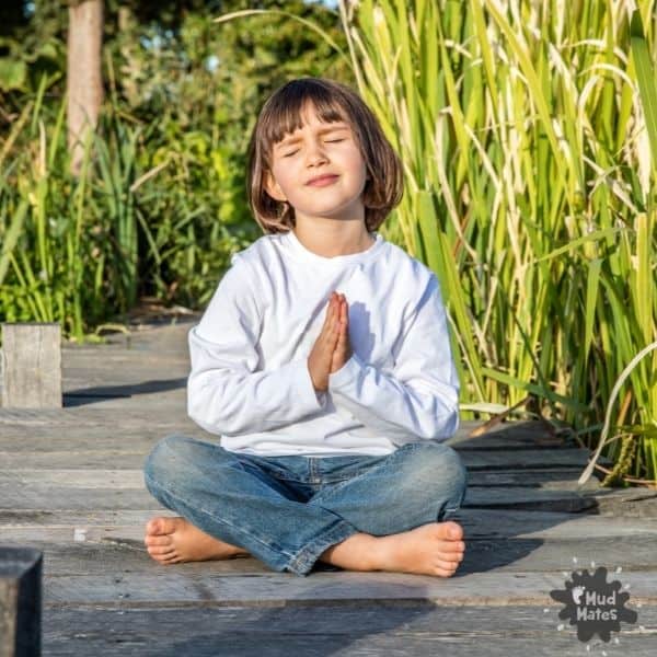 Young child sitting outside doing mindfulness activities