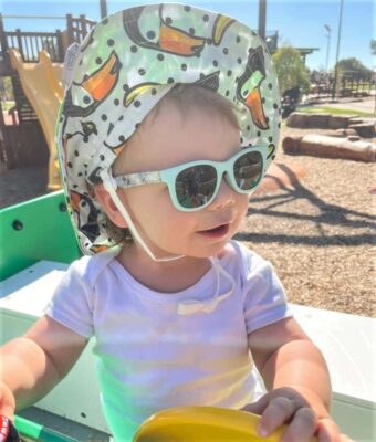 Baby/young toddler at the playground wearing Beachcombe Bicycle Ride kids sunglasses