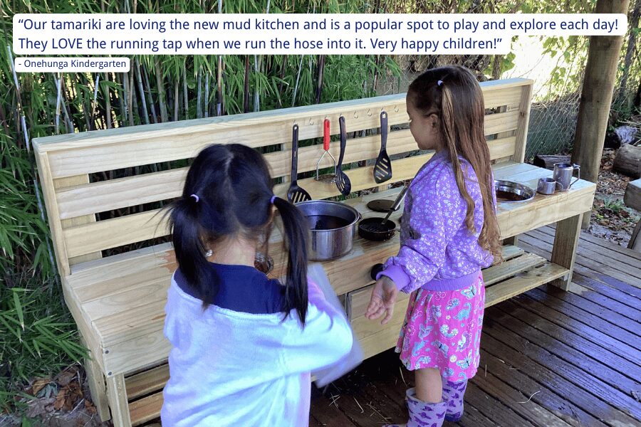 Young children at their early childcare centre, playing at their wooden Mud Kitchen from Mud Mates