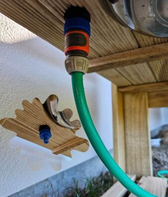 Garden hose attached to the underneath of the Mud Kitchen for running water from your Mud Mates Mud Kitchens