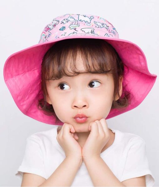 Young girl wearing a Cats and Unicorn design reversible sun hat. Shop UPF 50+ reversible kids sun hats