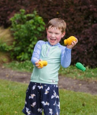 Boy having fun playing with reusable water balloons