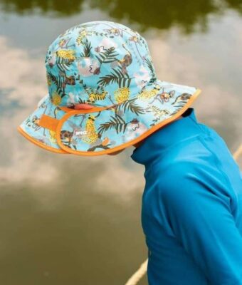 Young child wearing a Jungle design reversible sun hat. Shop UPF 50+ reversible kids sun hats