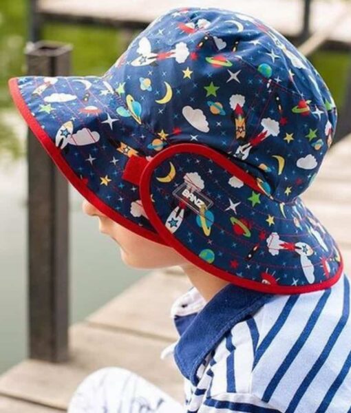Young child wearing Mud Mates UPF 50+ reversible kids sun hats in Space design