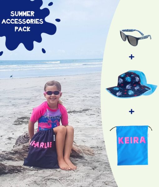 Young girl sitting on the beach with her Mud Mates Kids Summer Accessories Pack - includes NZ-made swim bag and cute, quality kids sunglasses and sun hat