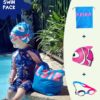 Save Money with a Kids Swim Pack: Toddler girl sitting by swimming pool with her personalised NZ-made swim bag, kids goggles and swim cap
