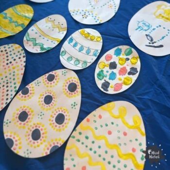 Easter craft for kids. A selection of colourful cardboard Easter eggs decorated using a cotton bud painting technique.
