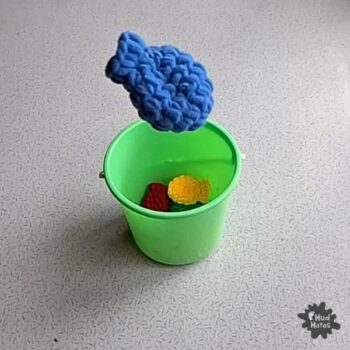 Indoor play idea using Reusable Water Balloons: balloon toss into a bucket