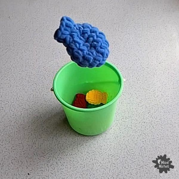 Indoor play idea using Reusable Water Balloons: balloon toss into a bucket
