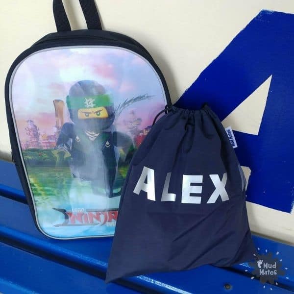 School bag and personalised swim bag on a bench, ready for back to school