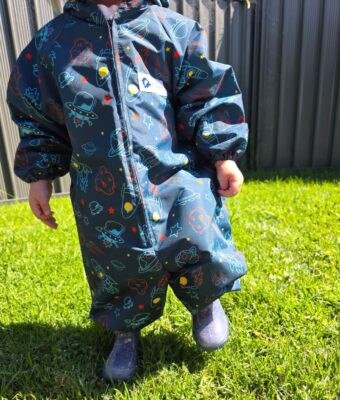 Durable, easy-clean coveralls that keep kids dry and protected during messy and outdoor play - shown here in our Space fabric