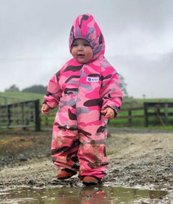 Young girl exploring the farm in her pink camo NZ-made children's coveralls