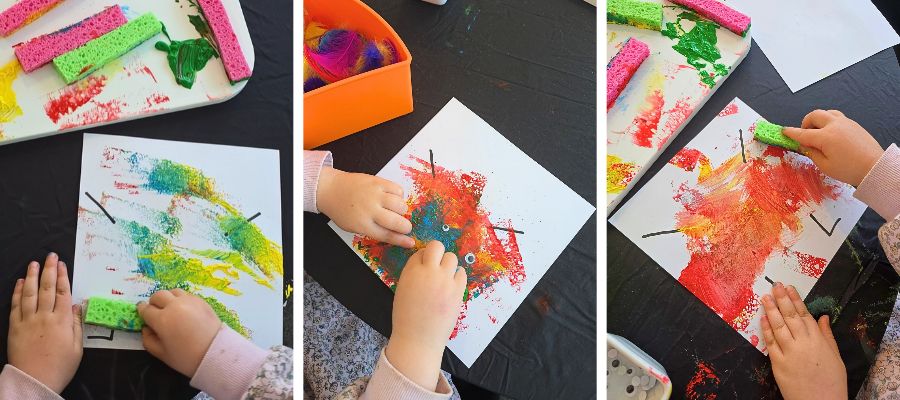 Child’s hands sponge painting a halloween monster craft - showing the stamping process in progress with colourful acrylic paint